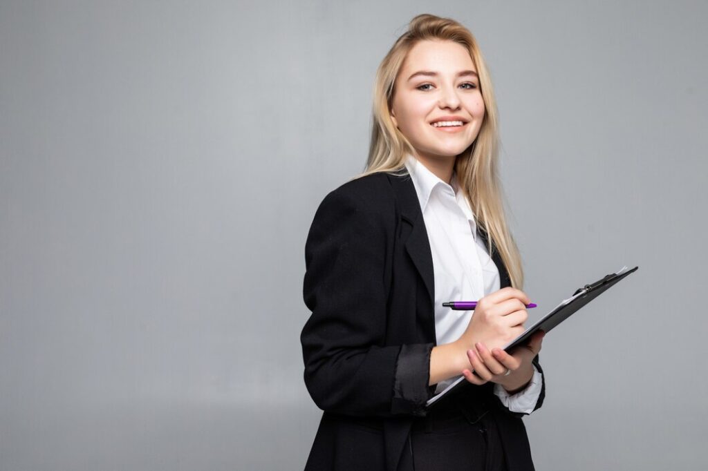 portrait woman holding clip board hands writing paper wearing glasses isolated grey wall 231208 209