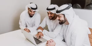 emirati men using laptop